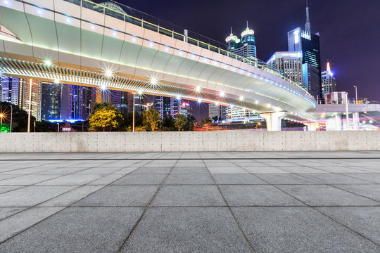 Empty square and modern city pedestrian bridge cityscape at night in Shanghai