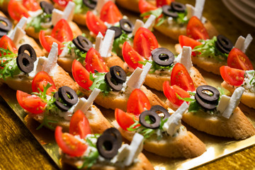 tiny sandwiches with olive green cheese and tomatoes