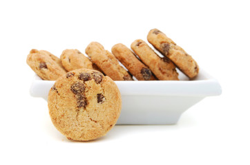 A stack of chocolate chip cookies in plate on a white background.