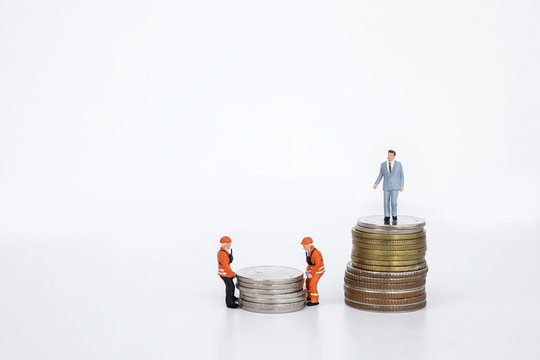 Financial concept, miniature business man standing on stack of coin and miniature worker moving coin on white background