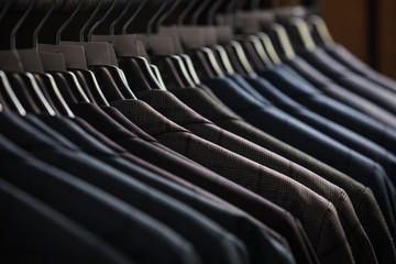 Rows of men's suit jackets in suitshop