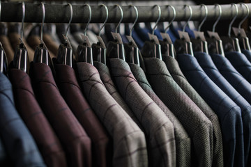 Row of men suit jackets on hangers