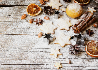 Christmas gingerbread cookies stars on a wooden table and cookie cutters, selective focus