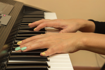 Fototapeta na wymiar Fingers playing electronic piano keyboards