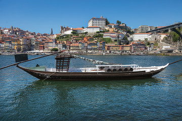 Traditional Rabelo Boat on the Bank of the River Douro and Colorful Facades of Typical Houses- Porto, Portugal