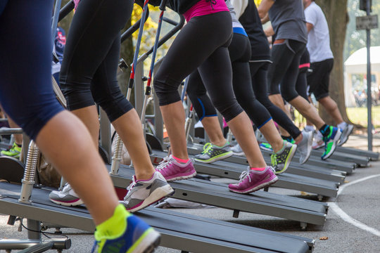 Women in Sportswear Exercising Outdoor on Treadmills