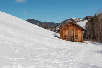 Small Wooden Shack Among Trees in Winter day with Fresh Snow in the Mountains, Winter Landscape