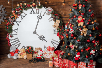 Beautiful holiday decorated living room with Christmas tree and presents. Big magical clock on wooden wall. Winter holidays design and decorations background.