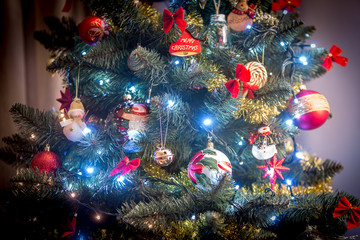Obraz na płótnie Canvas Various Christmas decorations on a tree in a home.