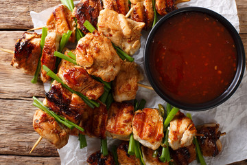 Chicken kebabs with green onions in a spicy sauce - Dakkochi close-up. Horizontal top view
