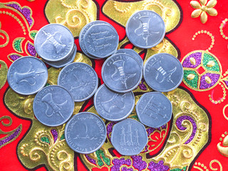 Chinese New Year decoration red bag with Arab coins dirhams.