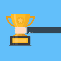 Creative flat design vector concept on businessman hand holding gold cup award icon. Winner prize goblet.