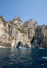 Fototapeta na wymiar Boats with tourists near Grotta Bianca and Grotta Meravigliosa, Capri, Italy