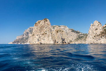Fototapeta na wymiar View from the boat on the cliff coast of Capri Island, Italy
