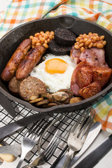 full british breakfast, prepared in a cast iron pan