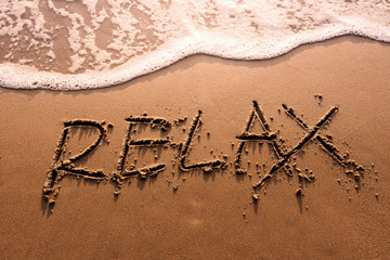 Relaxation Concept, Relax Word Written on Summer Sand Beach with Wave of Sea, Top View