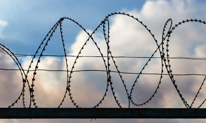 Fence with barbed wire as a background