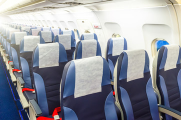 Passenger seat, Interior of airplane with passengers sitting on seats.