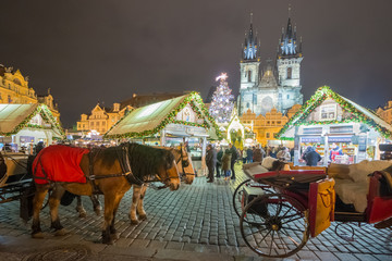 Christmas Markets on the Old Town Square in Prague with Team of Horses in the foreground.