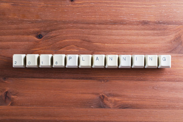 Planning 2018 new year on computer keyboard keys buttons on wooden background