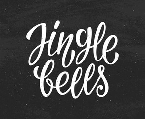 Jingle Bells white text on black chalkboard background. Modern calligraphy lettering for season greetings. Vector vintage greeting card