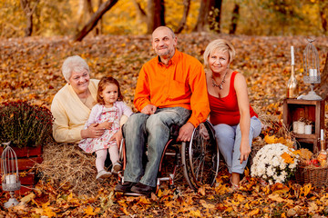 Fototapeta premium The grandparents and granddaughter sitting on the hays