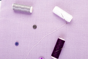 Items for sewing clothes. Sewing buttons, spools of thread and cloth. Top view.