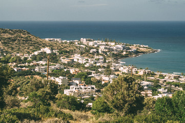 View from the Bulgarian Trail on Crete, Greece. Sunny village on the seacoast.