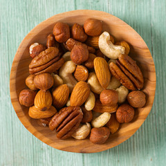 mixed nuts on wooden surface