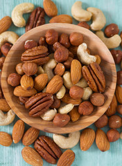 mixed nuts on wooden surface