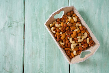 mixed nuts on wooden surface