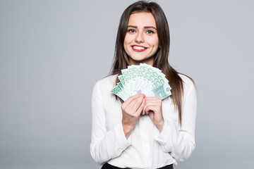 Young woman holding euro money isolated on white background - obrazy, fototapety, plakaty