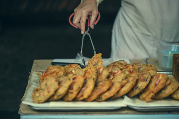 A man selling a traditional local food on the the local market in Chinatown, Kuala lumpur. Street food  in Kuala lumpur, Malaysia