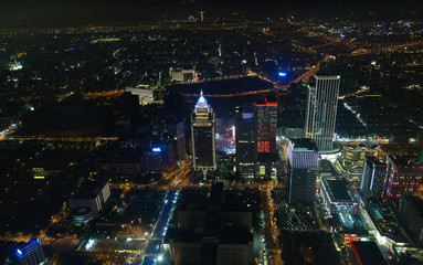 Taipei's colorful cityscape at night.  Visible noise due to high ISO and wide aperture.
