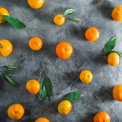 Fruit pattern of fresh citrus with leaves arrangement on dark background. Flat lay. Top view