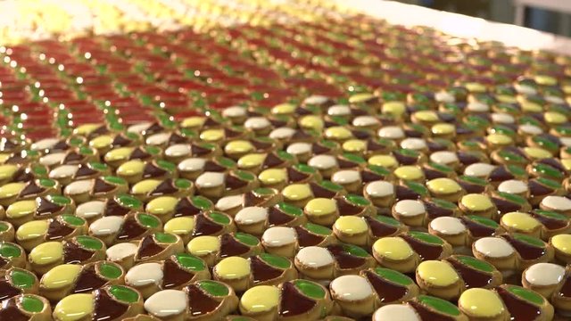 Cake with jam. A large number of cookies with jam lie on a large table