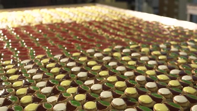 Cake with jam. A large number of cookies with jam lie on a large table