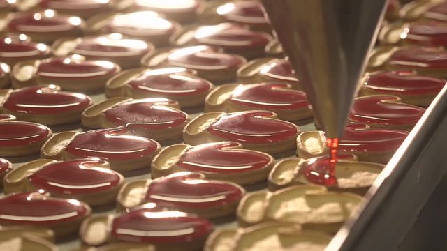 Jam pour into the cookies. Jam and cookies. Red jam. Red cream.