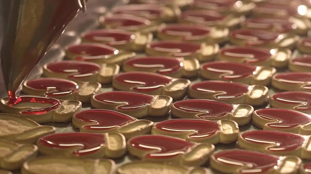 Jam pour into the cookies. Jam and cookies. Red jam. Red cream.