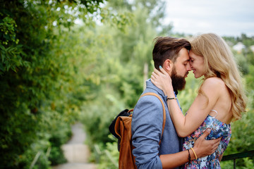 Fototapeta premium A young couple is kissing in a sheet. Family holiday. Romance relations.