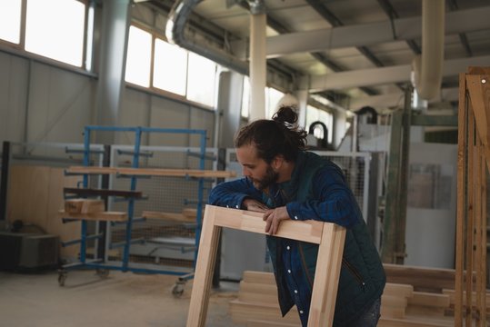Carpenter making wooden frame