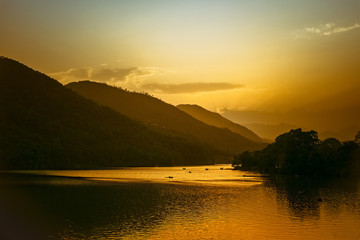 magical orange watm sunset in lake with many boats. nepal © Sergio de Flore