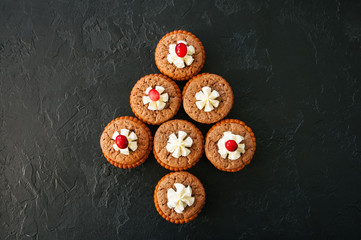 Brownie mins pies on a black background.
