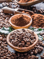 Roasted coffee beans  and ground coffee on wooden table. Top view.