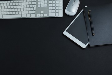 Keyboard, mouse, digital tablet, pen and organizer on black