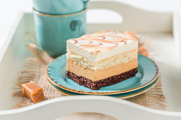Tasty toffee cake on blue porcelain with fudge bars