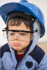 Young boy with work helmet ready for continue working in little constructions