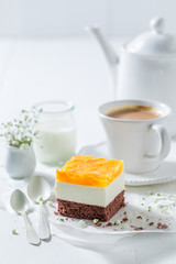 Delicious cake with jelly and peaches served with coffee