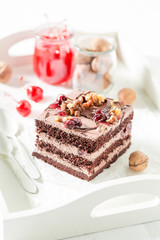 Fresh chocolate cake with cherry and nuts