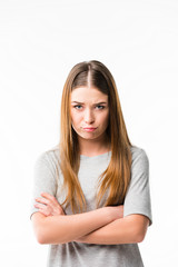 Fototapeta premium portrait of emotional woman with arms crossed looking at camera isolated on white
